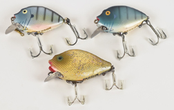 Three Heddon Punkin Seed Fishing Lures
